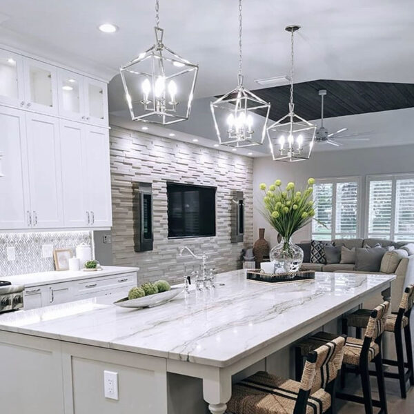 kitchen with pendant lighting, recessed lights, and under cabinet lighting. Large screen tv mounted in adjoined den.